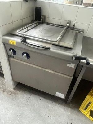 a stove with a pan on top of it in a kitchen