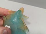 a person that is holding a piece of glass in their hand