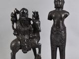 pair of bronze figurines of a woman and a man on a horse