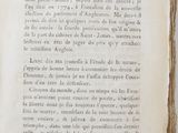 an old book with writing on it sitting on a table