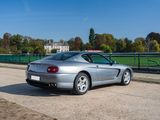 a silver sports car parked on the side of the road