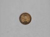 a gold coin sitting on top of a white surface