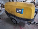 a yellow box on a trailer in a garage