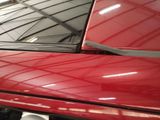 a close up of a red car in a garage