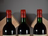 three bottles of wine that are sitting on a table