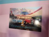 a picture of a car showroom with cars parked in front of it