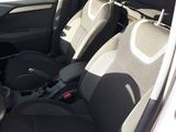 the interior of a small car with black and white seats