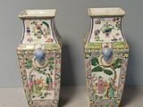 two vases sitting next to each other on a table