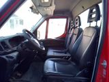 a red truck with black leather seats in the back of it