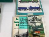 three books on a table with a train on the cover