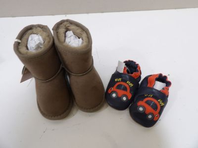 a pair of boots and a pair of baby shoes on a table