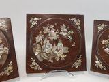 three pieces of wood with flowers and leaves on them
