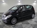 a picture of a black mercedes b - class parked in a showroom