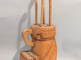a clay sculpture of a golf bag and a bag of golf clubs