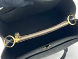 a black purse with a gold zipper on the inside of it