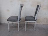 two chairs sitting next to each other on a cement floor