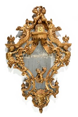 a mirror with a gold frame and a clock on it