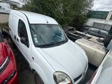 a white van parked next to other cars in a parking lot