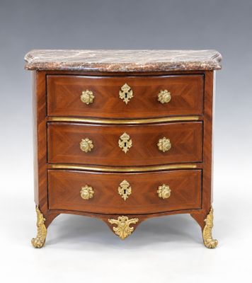 an antique chest of drawers with marble top