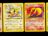 pokemon cards are lined up in a row on a black background