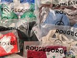 many bags of clothing that are on a table