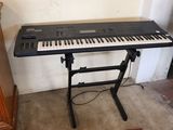 a keyboard that is sitting on a stand in a room