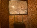 a suitcase sitting in the corner of a room with brick walls