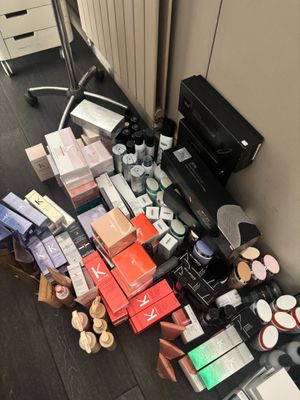 a lot of makeup and makeup products on the floor