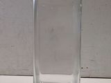 a clear glass vase sitting on a white table