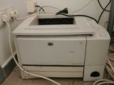 a printer that is sitting on the floor next to a wall