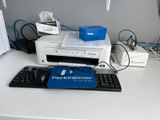 a keyboard, mouse, and printer sitting on a desk