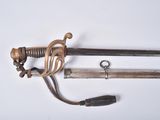 two swords that are laying next to each other on a table