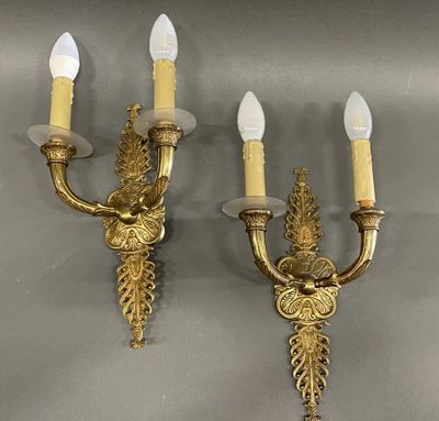 pair of antique brass wall sconces with white candles