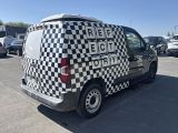 a black and white checkered van parked in a parking lot
