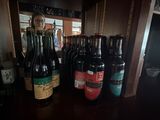 many bottles of beer sitting on a shelf in a room