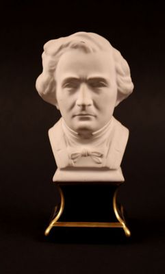a close up of a bust of a man with a bow tie