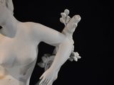 a statue of a woman holding a bird on her arm