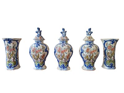 four vases with different designs are lined up against a white background