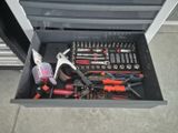 many tools in a tool box on the floor
