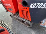 a close up of a red and black machine on a street