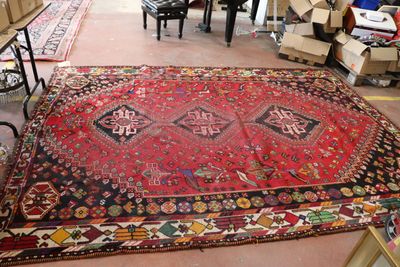 a large red rug on the floor in a room