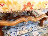 a close up of a wooden foot rest on a couch