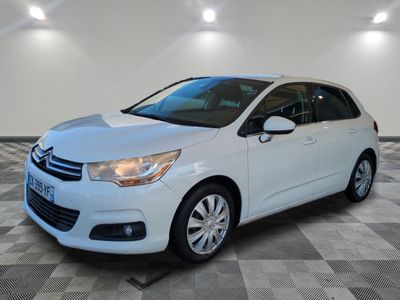 a white citrole parked on a checkered floor in a garage