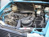 a blue car with a engine in the trunk