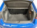 the back of a blue car with its trunk open and the seat down