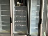 three refrigerators that are sitting in the middle of the floor