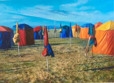 de nombreux parasols posés dans l'herbe près de la plage