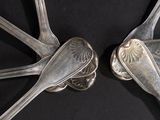 two spoons that are sitting next to each other