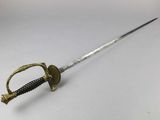 a close up of a sword with a handle on a white surface