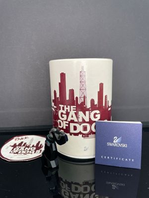 une tasse à café avec un autocollant dessus, à côté d'une carte cadeau
